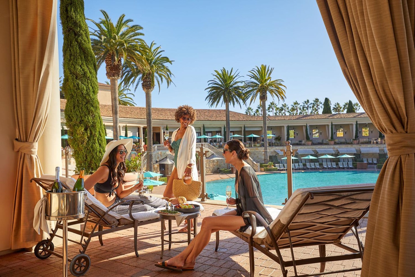 women at the coliseum pool cabana