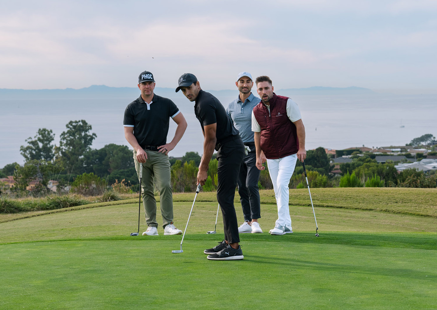 four golfers on the pelican hill golf course tee